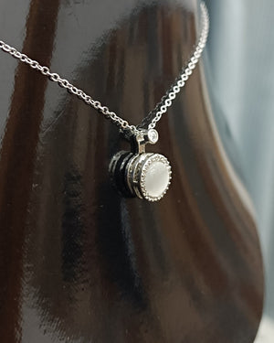 Elegant Silver Pendant Necklace with White Gemstone and Diamond Accents